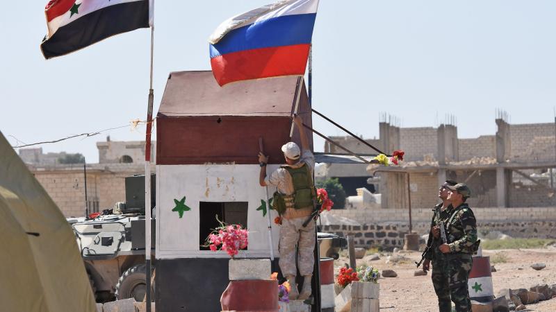 Krievijas karavīrs pie Sīrijas bruņoto spēku kontrolposteņa izvieto Krievijas karogu