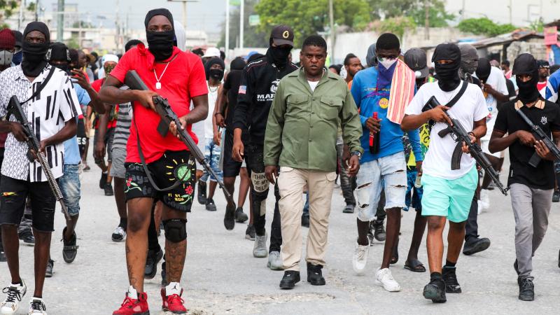 Bijušais policists Džimijs "Bārbekjū" Čerizjē, G9 koalīcijas līderis, vada gājienu, kuru ieskauj viņa apsardze pret Haiti premjerministru Arielu Henriju.